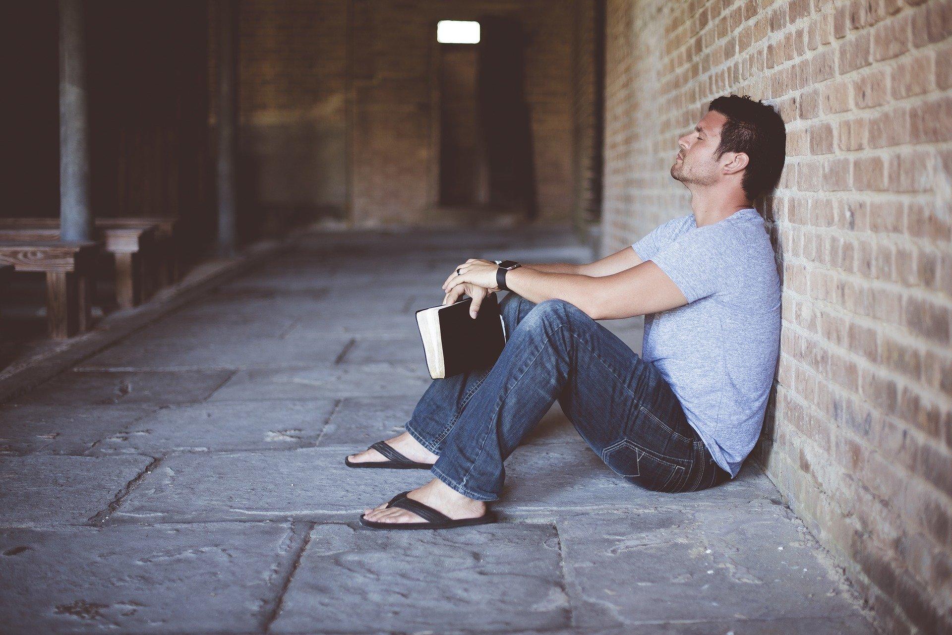 Sad man holding Bible